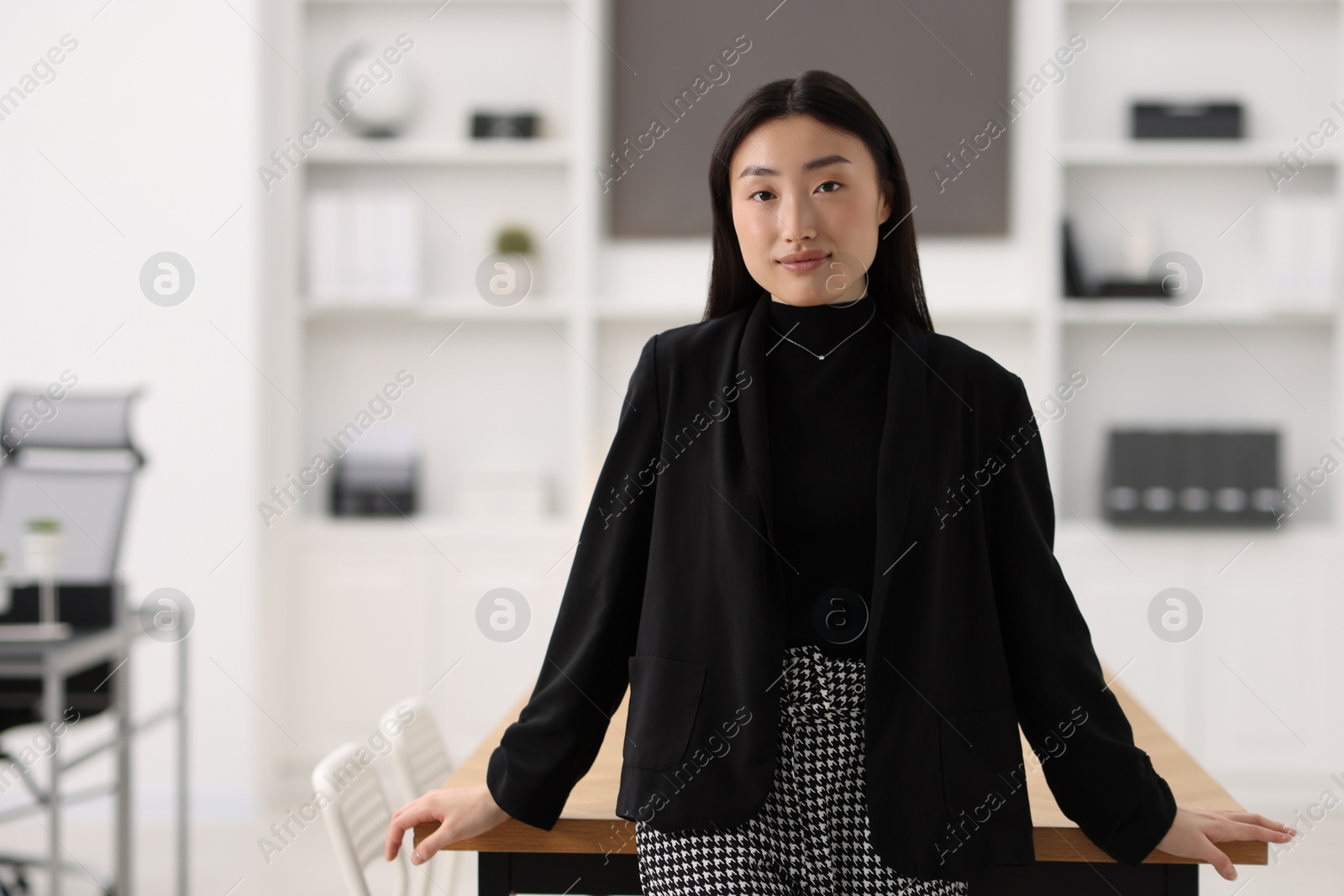 Photo of Portrait of beautiful businesswoman in office. Space for text