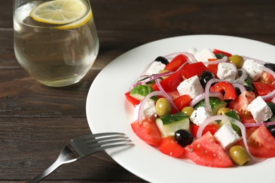 Photo of Plate with delicious salad on table, closeup