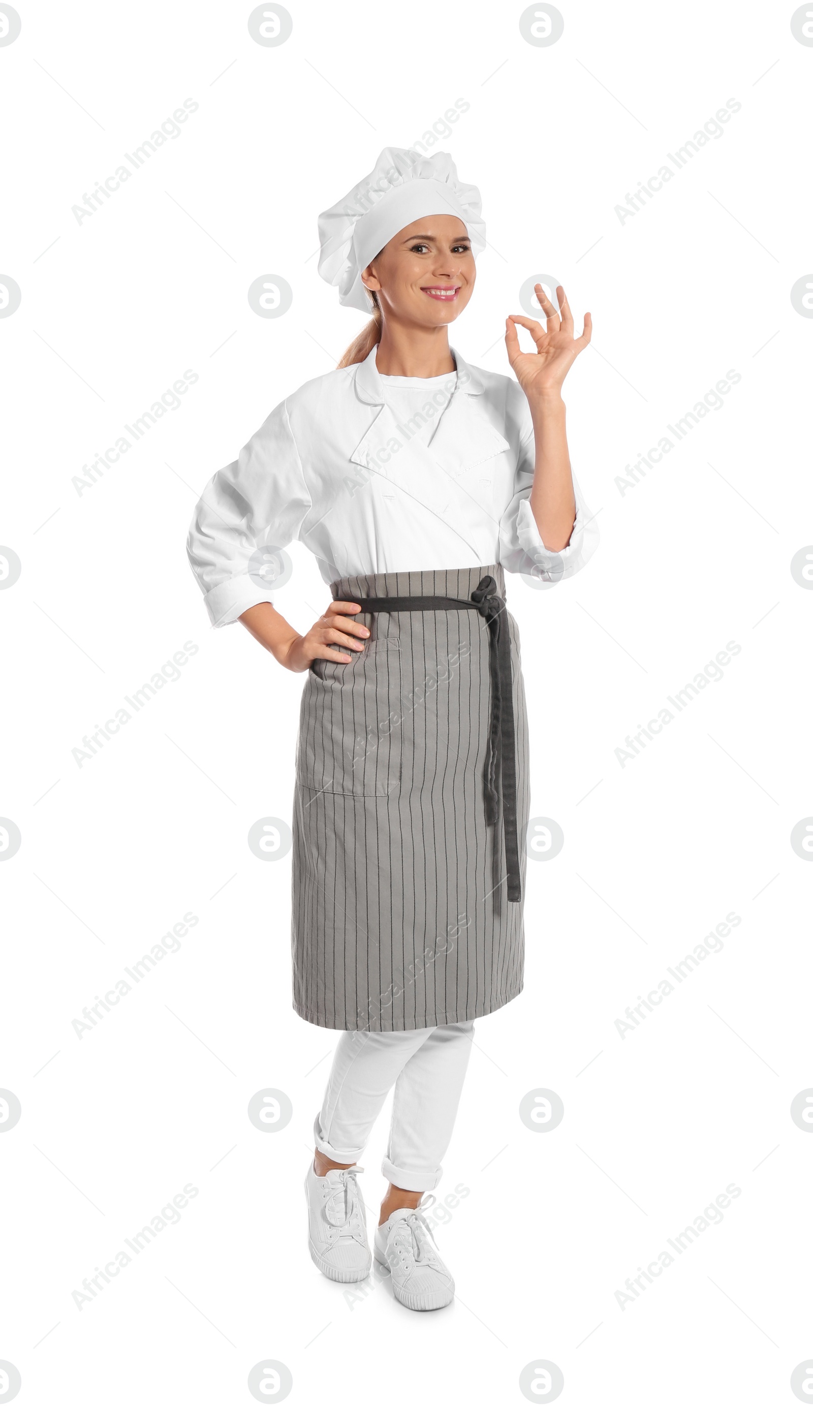 Photo of Female chef in apron showing perfect sign on white background