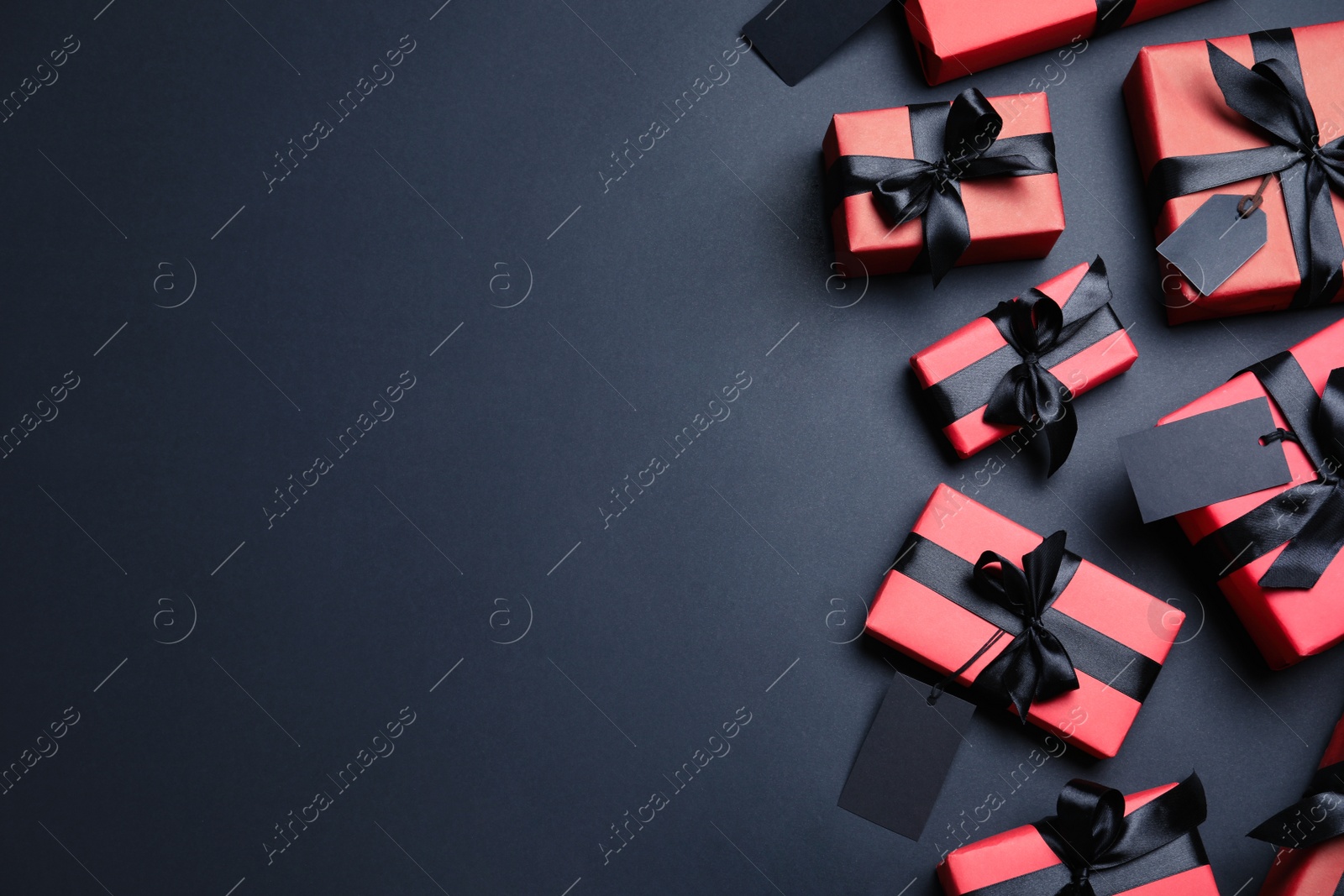 Photo of Gift boxes and space for text on dark background, flat lay. Black Friday sale