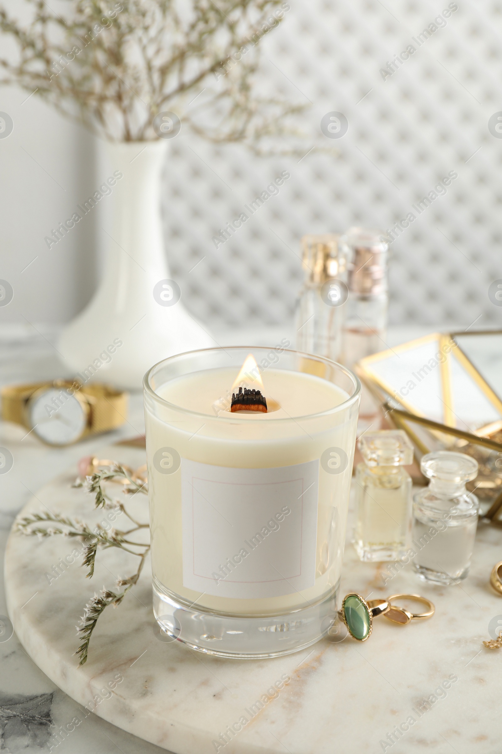 Photo of Composition with burning soy candle on white marble table