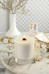 Photo of Composition with burning soy candle on white marble table