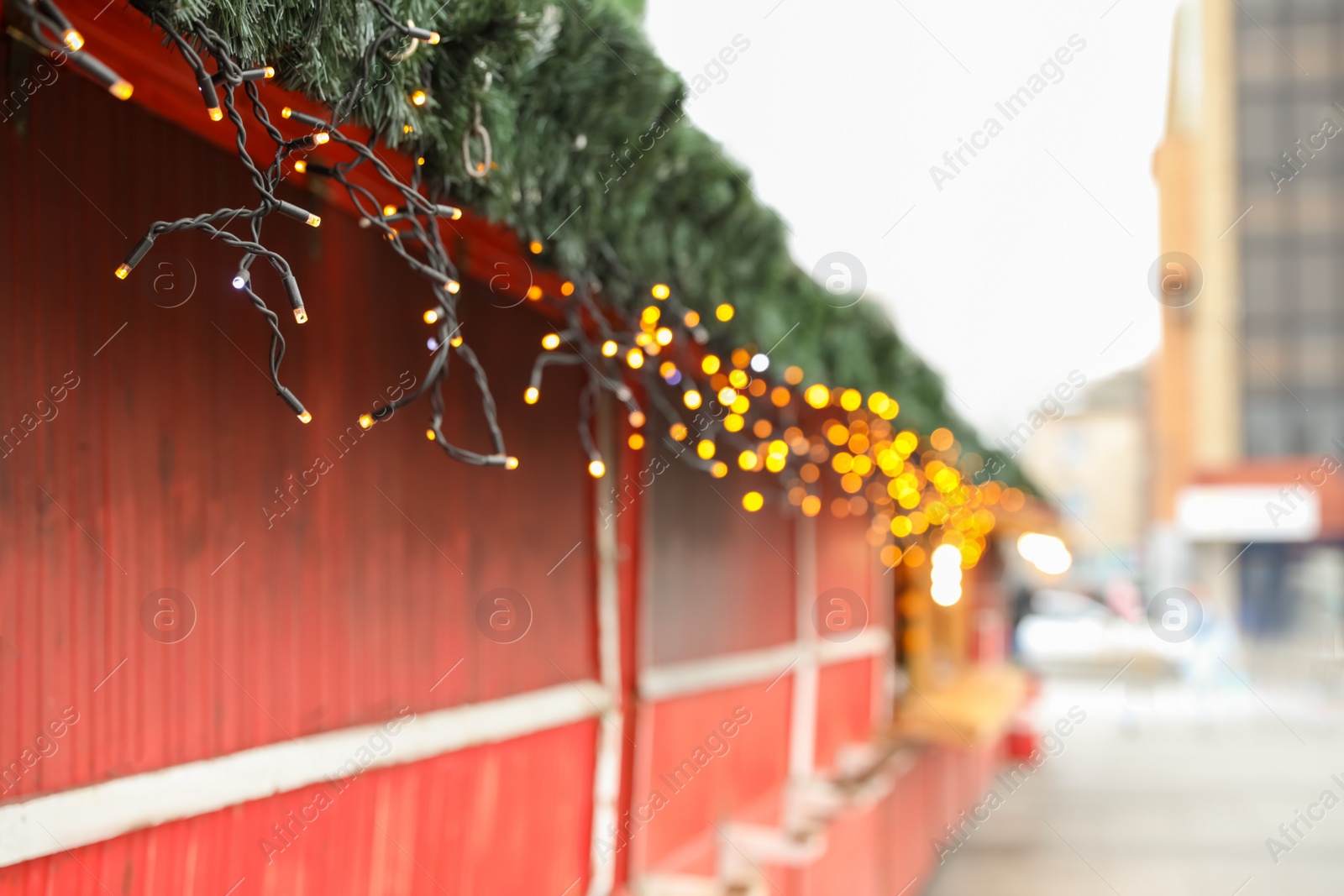 Photo of Christmas fair stall with string lights outdoors