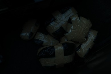 Photo of Packages with narcotics on black background, Drug addiction