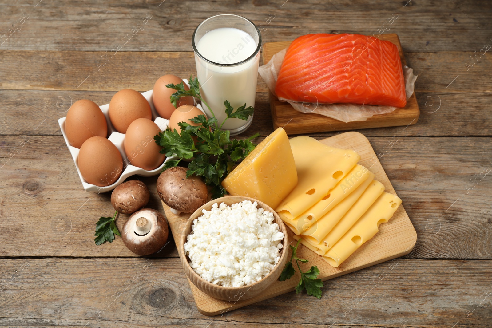 Photo of Fresh products rich in vitamin D on wooden table