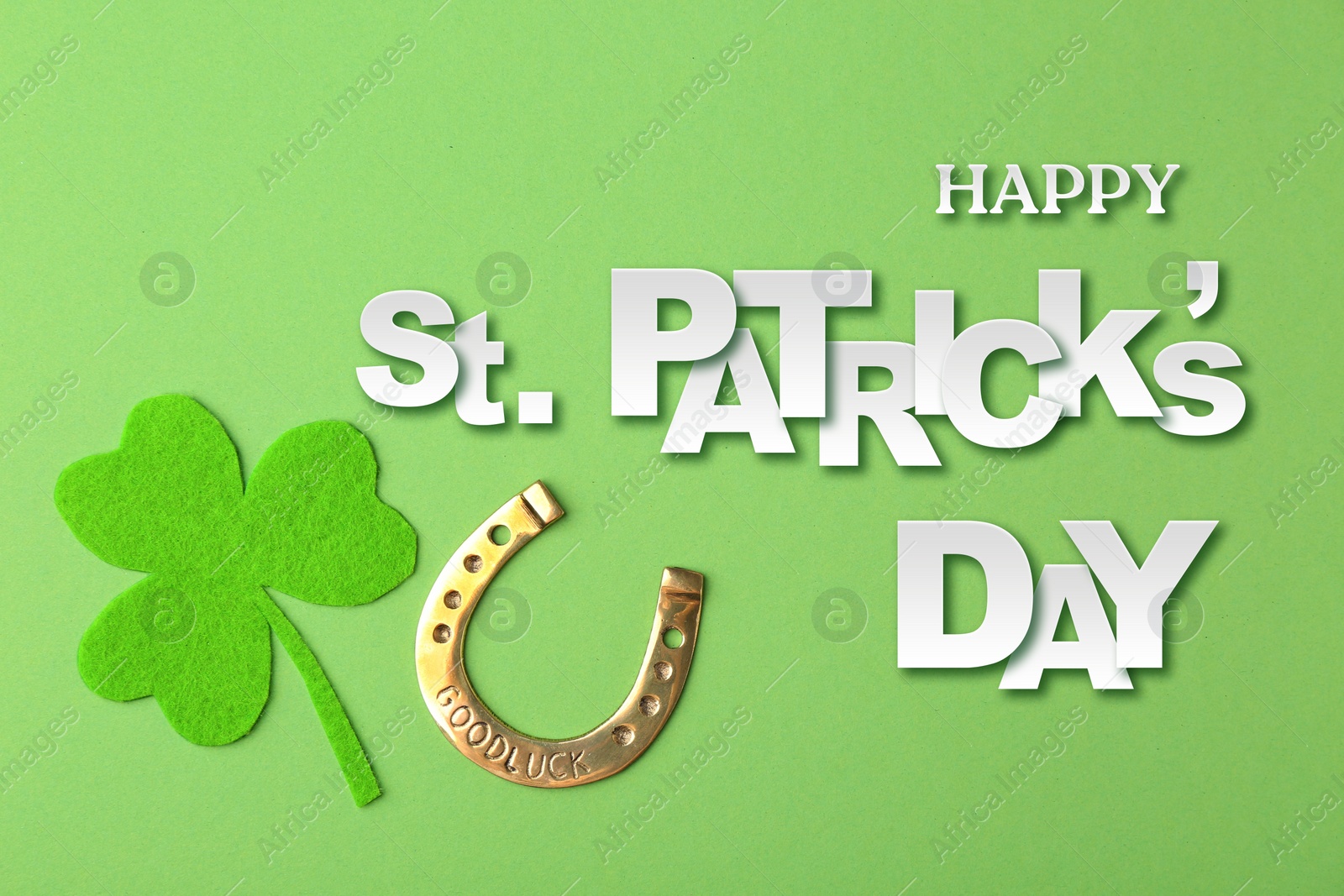 Image of Happy St. Patrick's day card. Golden horseshoe, decorative clover leaf and text on green background, top view