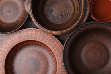 Photo of Set of clay dishes on table, flat lay. Cooking utensils
