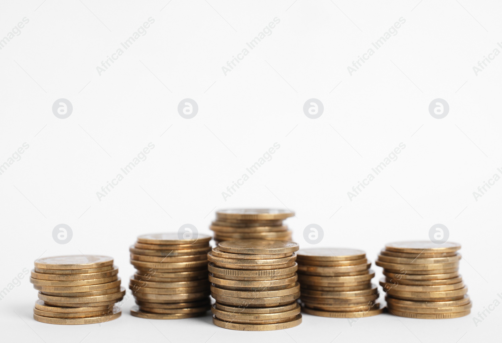 Photo of Many Euro coins stacked on white background