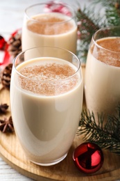 Delicious Christmas cocktail with liqueur on wooden board, closeup