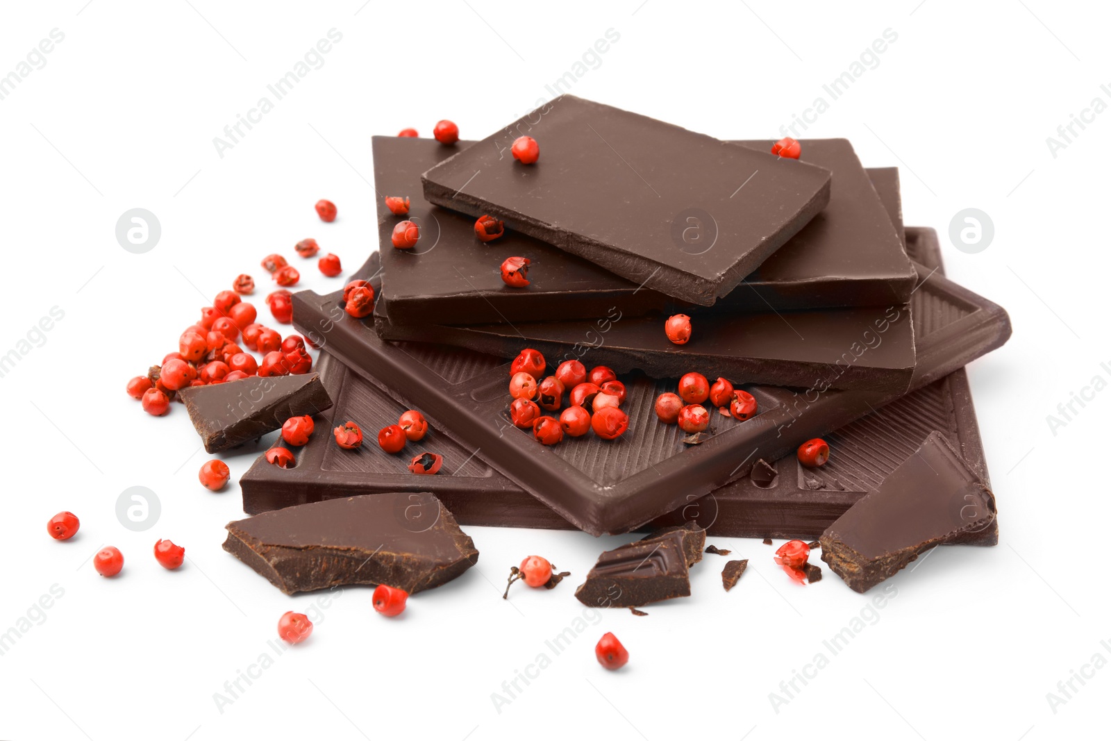 Photo of Red peppercorns and pieces of dark chocolate isolated on white