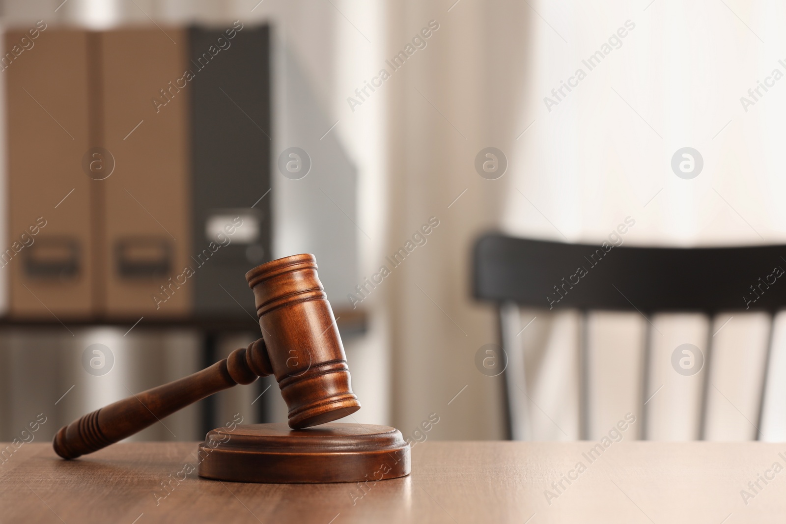 Photo of Law concept. Gavel on wooden table in office, space for text