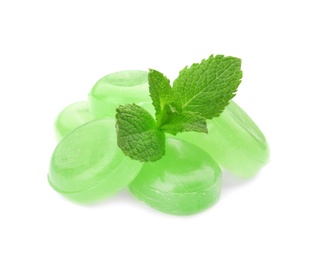 Photo of Tasty mint candies and leaves on white background