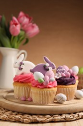 Photo of Tasty cupcakes with Easter decor on table