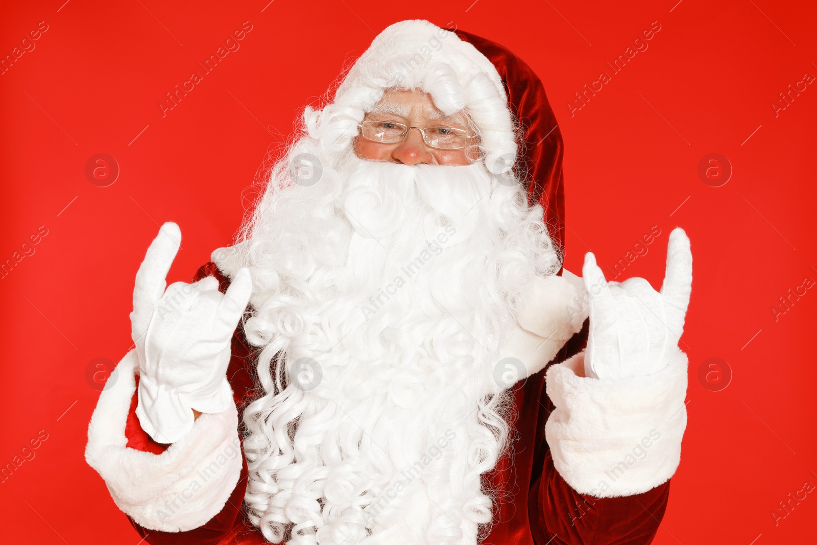 Photo of Happy authentic Santa Claus on red background