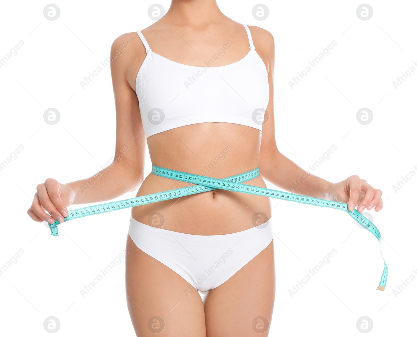 Photo of Slim young woman with smooth gentle skin in underwear measuring body on white background