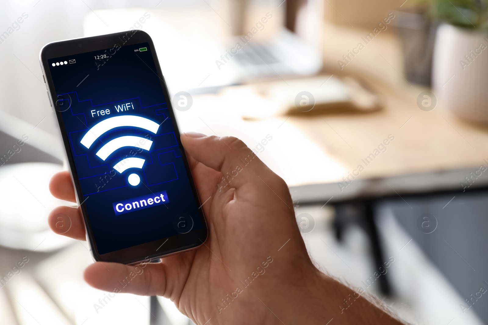 Image of Man connecting to WiFi using mobile phone indoors, closeup