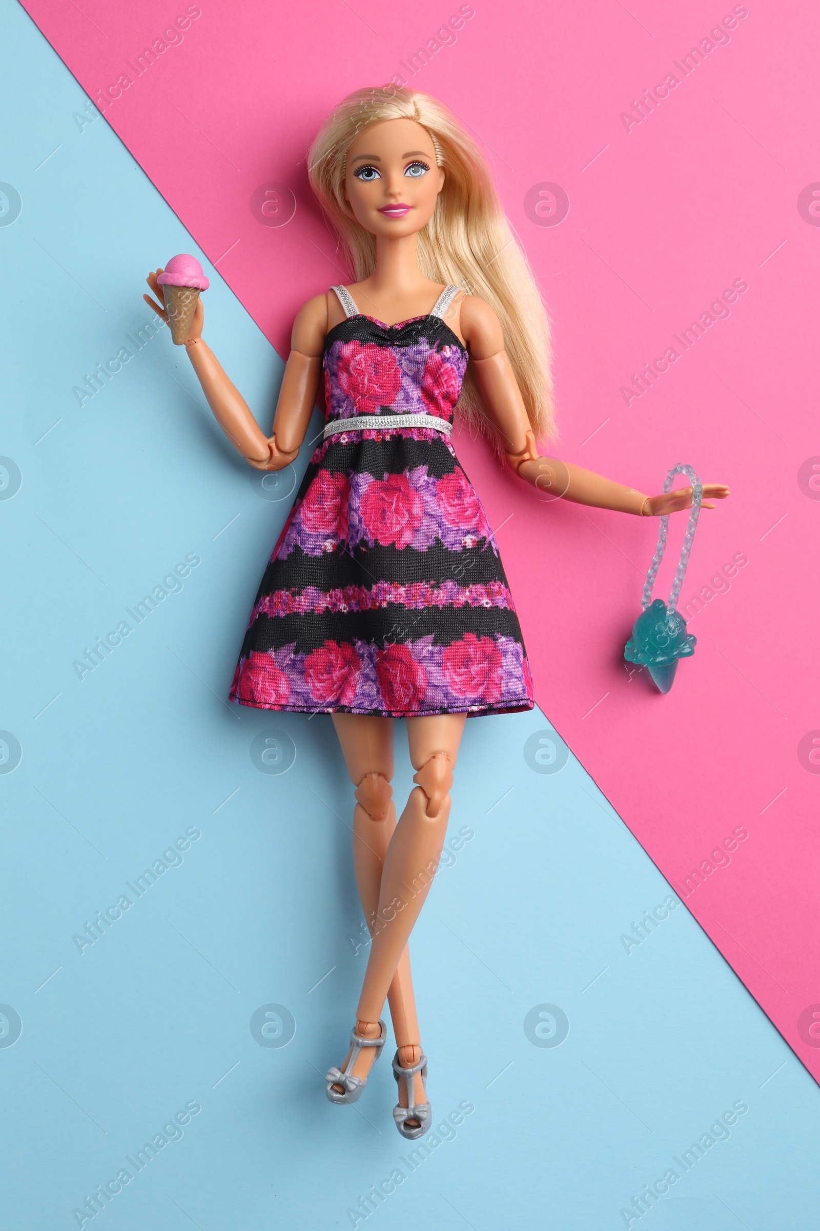 Photo of Mykolaiv, Ukraine - September 4, 2023: Beautiful Barbie doll with ice cream and bag on color background, top view