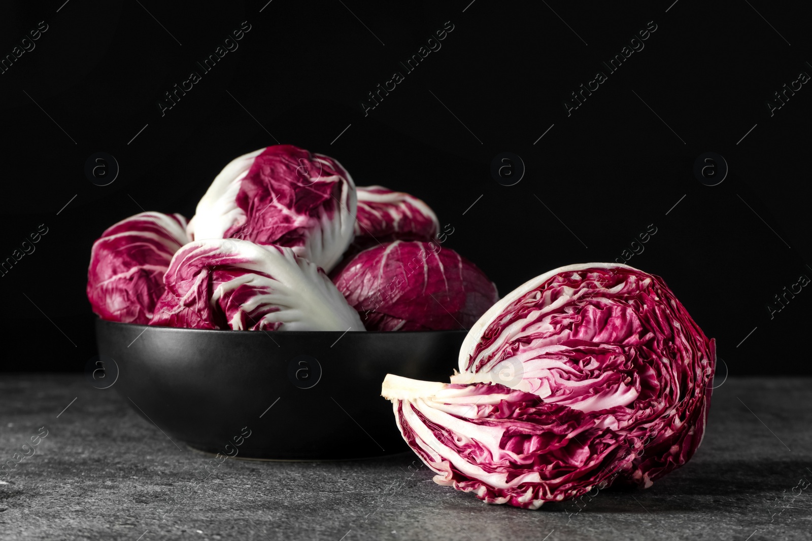 Photo of Whole fresh ripe radicchios on grey table