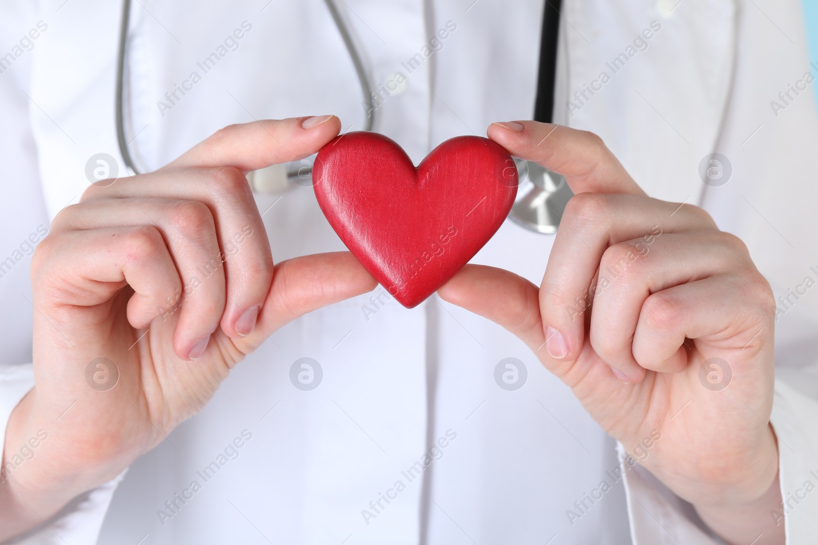 Photo of Doctor with red decorative heart, closeup view