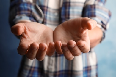 Photo of Woman asking for help on color background, focus on hands