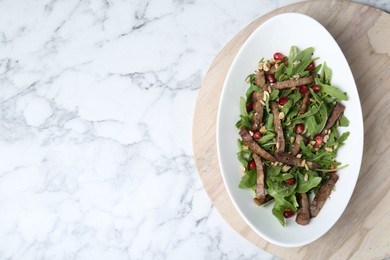 Delicious salad with beef tongue, arugula and seeds on white marble table, top view. Space for text