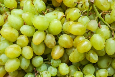 Fresh ripe juicy white grapes as background, closeup view