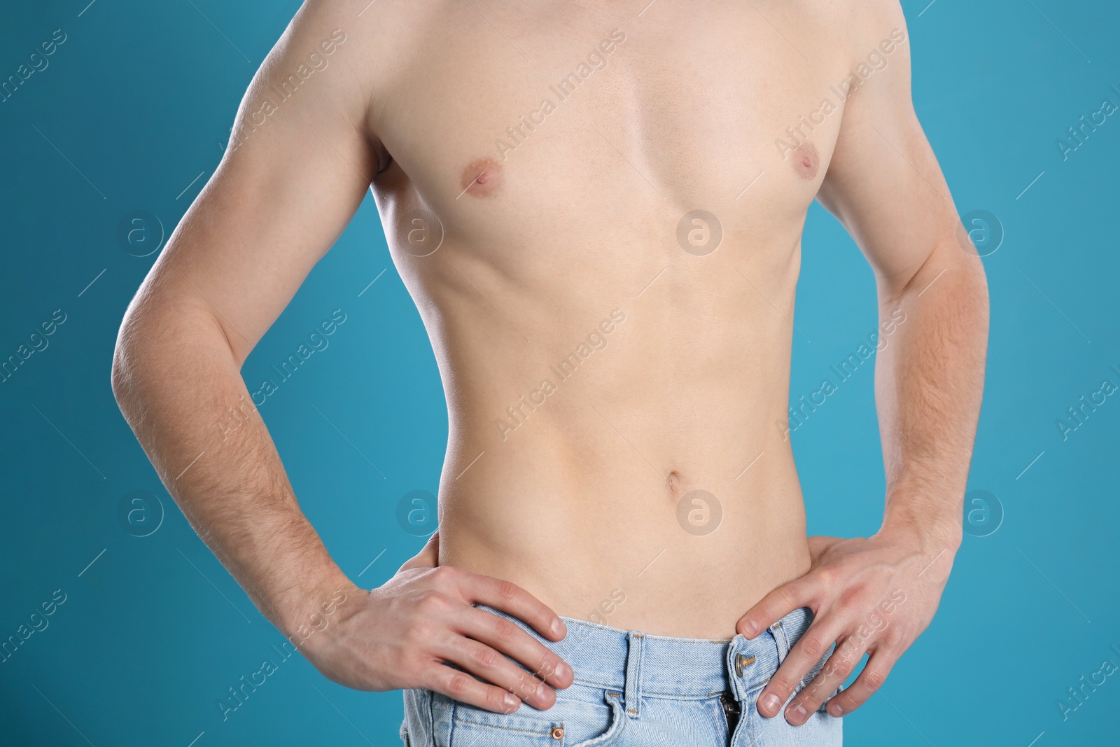 Photo of Man with slim body on color background, closeup