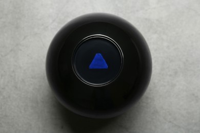 Photo of Magic eight ball on grey table, top view