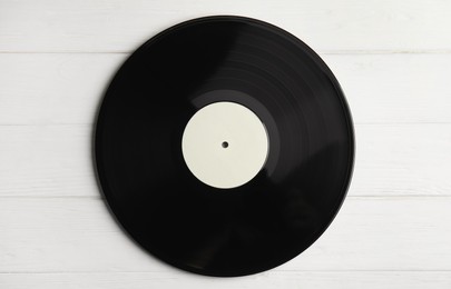 Photo of Vintage vinyl record on white wooden table, top view