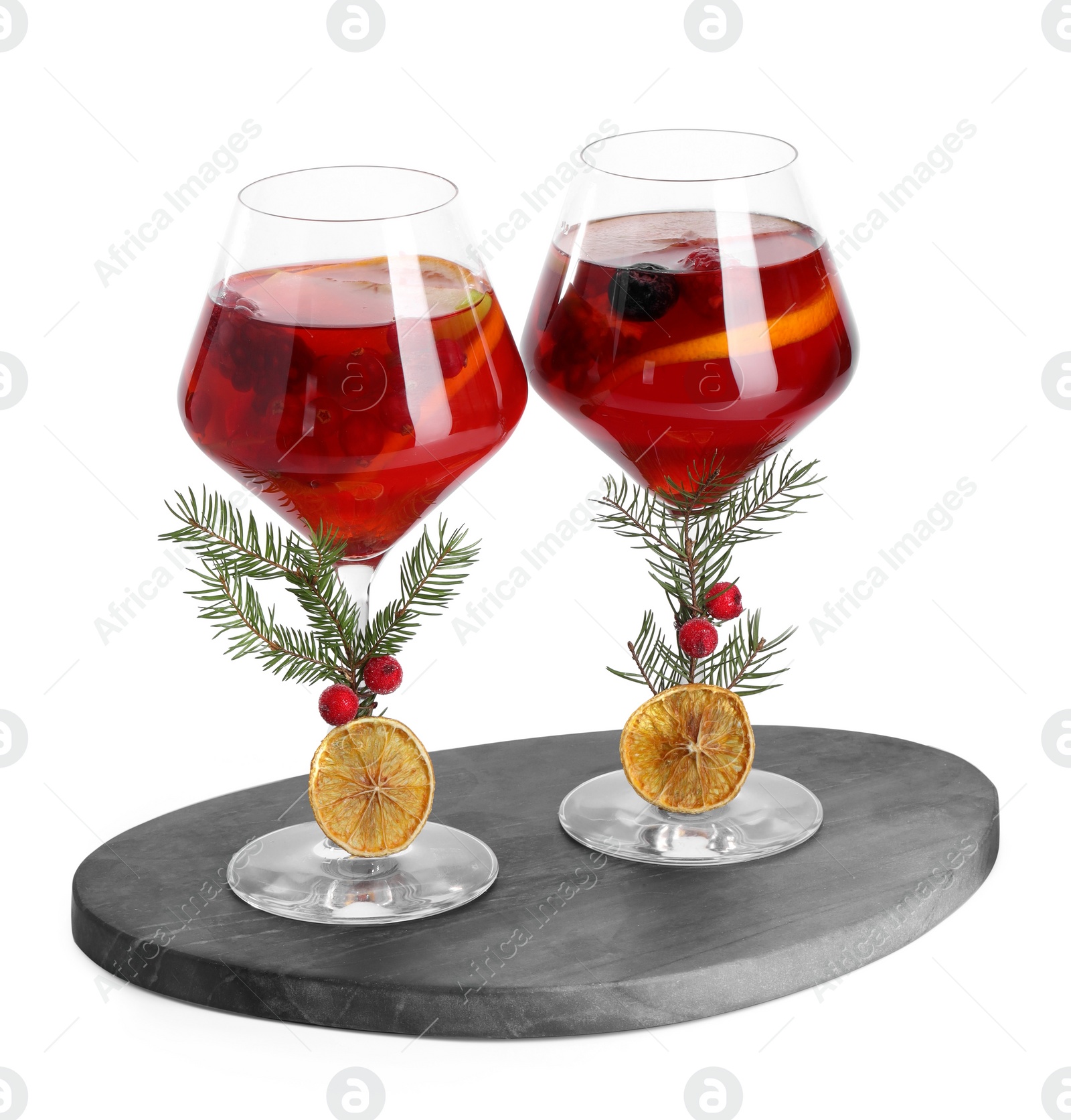 Photo of Christmas Sangria cocktail in glasses isolated on white