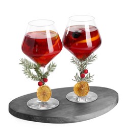 Photo of Christmas Sangria cocktail in glasses isolated on white
