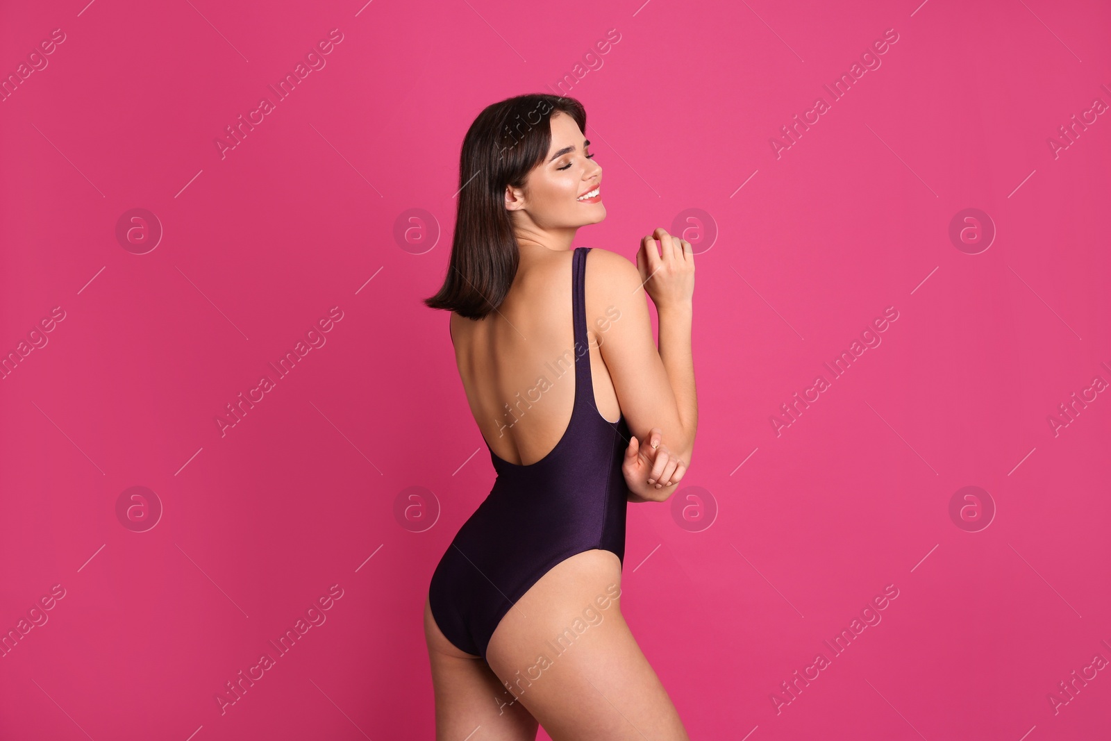 Photo of Beautiful woman in stylish swimsuit on pink background