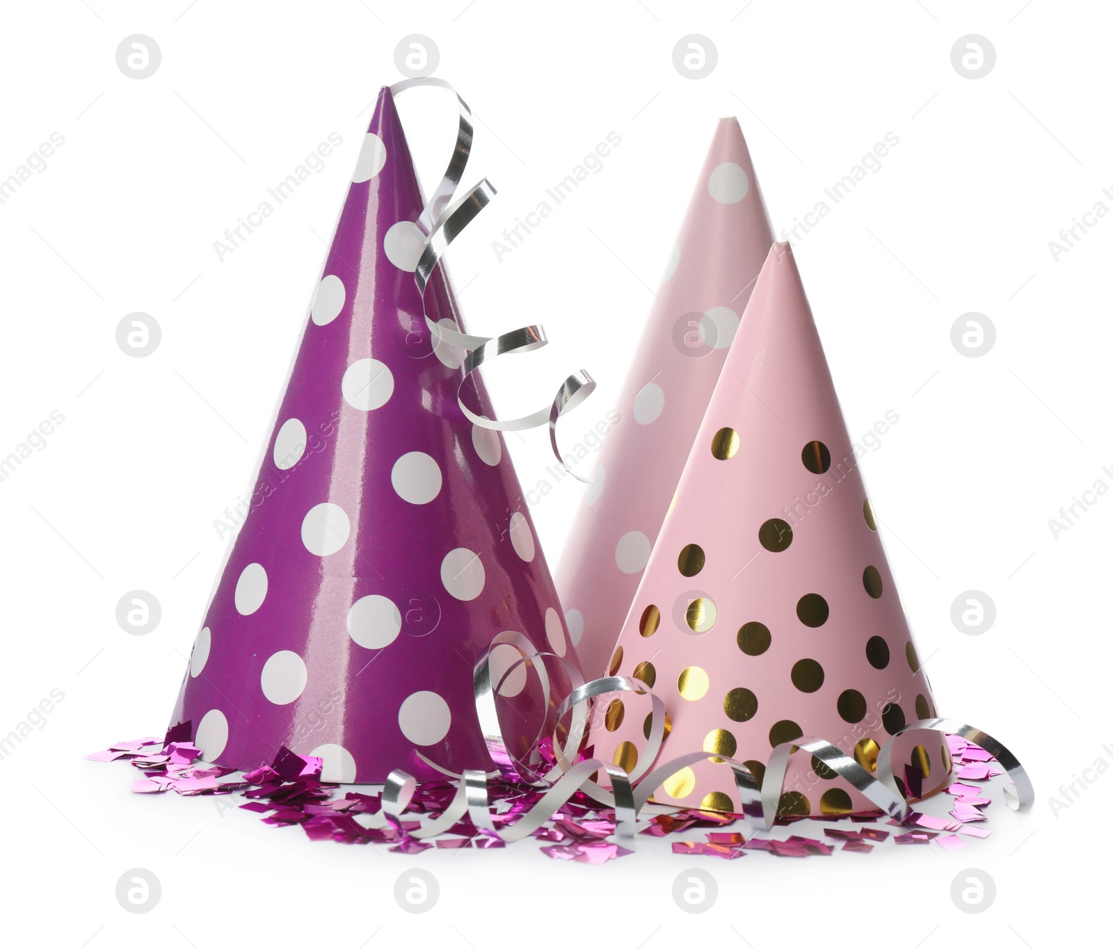 Photo of Colorful party hats and confetti on white background