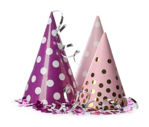 Photo of Colorful party hats and confetti on white background