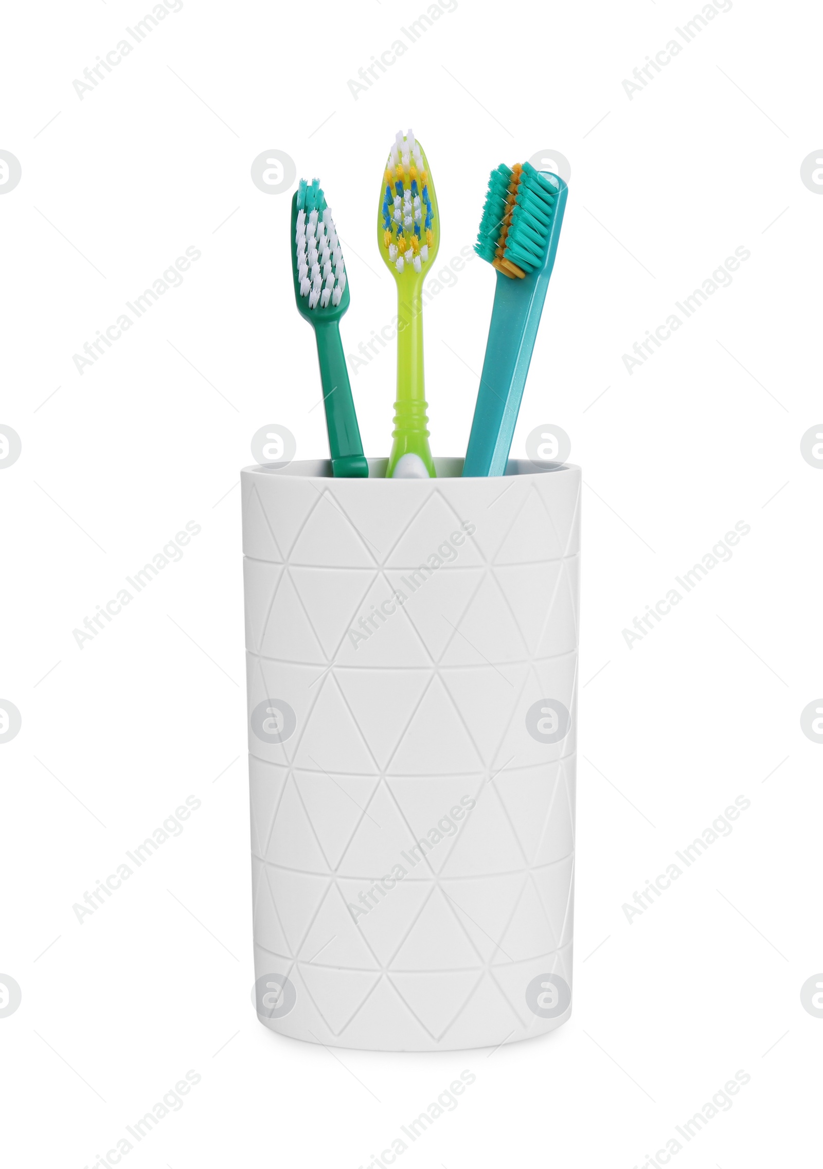 Photo of Different toothbrushes in holder isolated on white