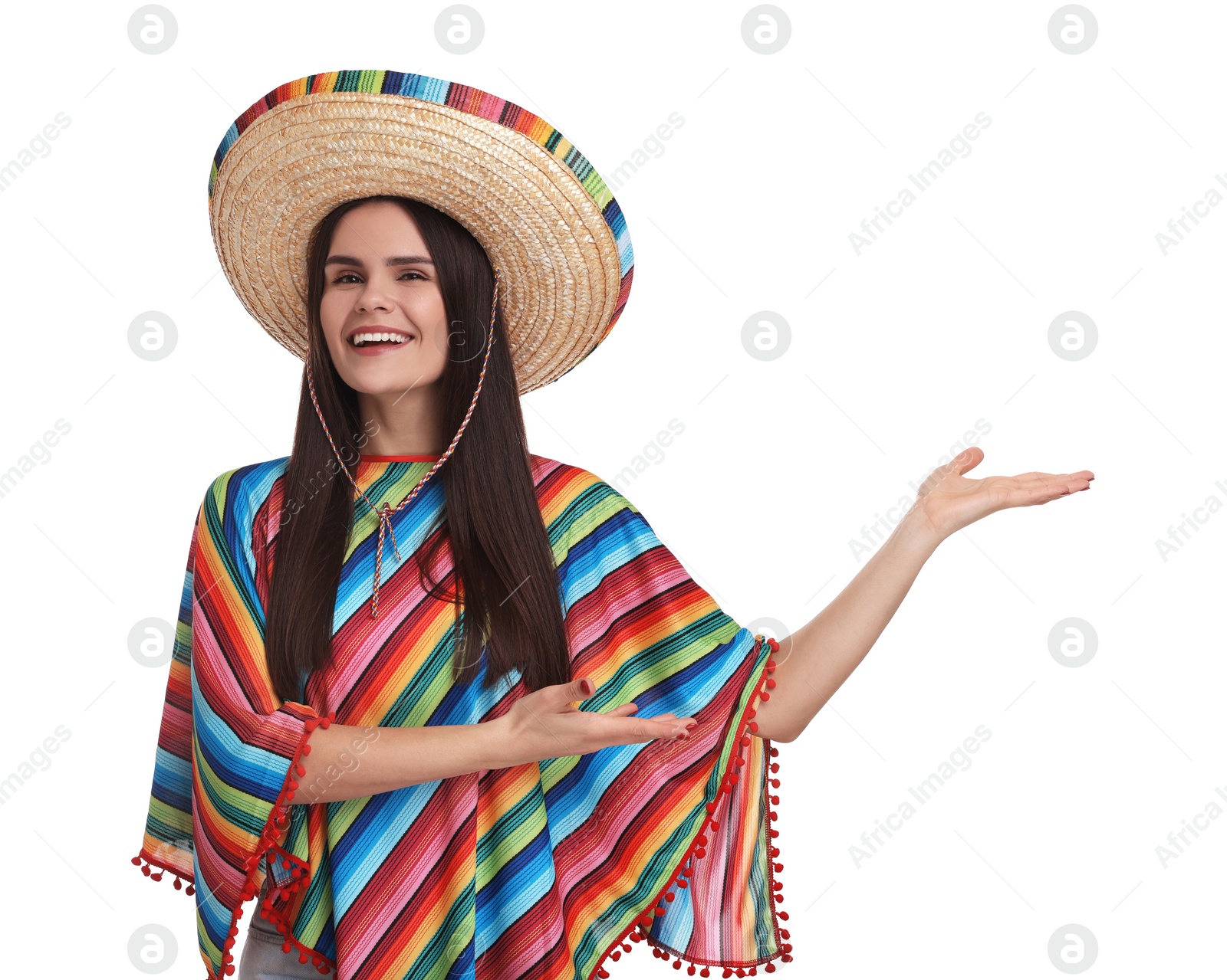 Photo of Young woman in Mexican sombrero hat and poncho showing something on white background