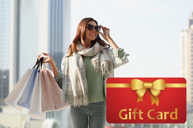 Image of Store gift card. Happy woman with shopping bags 