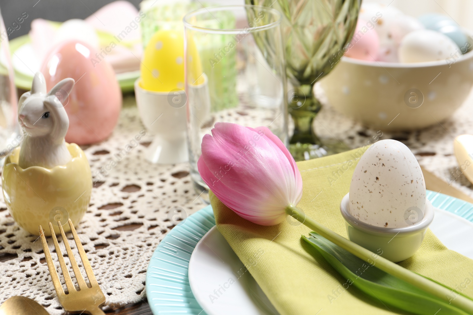 Photo of Festive table setting with beautiful tulip, closeup. Easter celebration