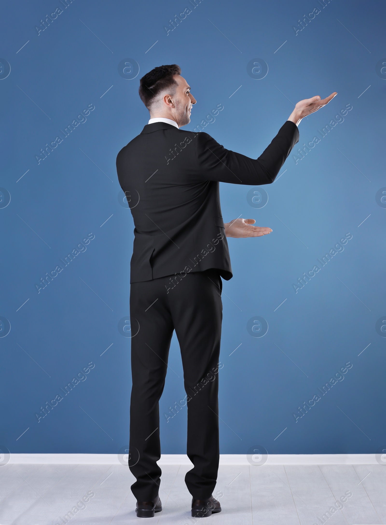 Photo of Young business trainer against color wall