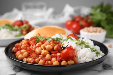 Photo of Plate with delicious chickpea curry on table, closeup