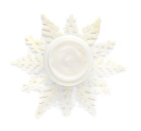 Photo of Jar of cream and snowflake on white background, top view. Winter skin care