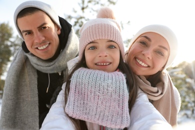 Photo of Happy family taking selfie outdoors on winter day. Christmas vacation