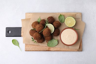 Photo of Delicious falafel balls served on light table, top view