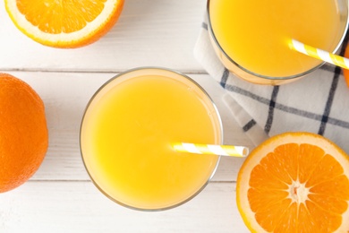 Flat lay composition with fresh orange juice on wooden background