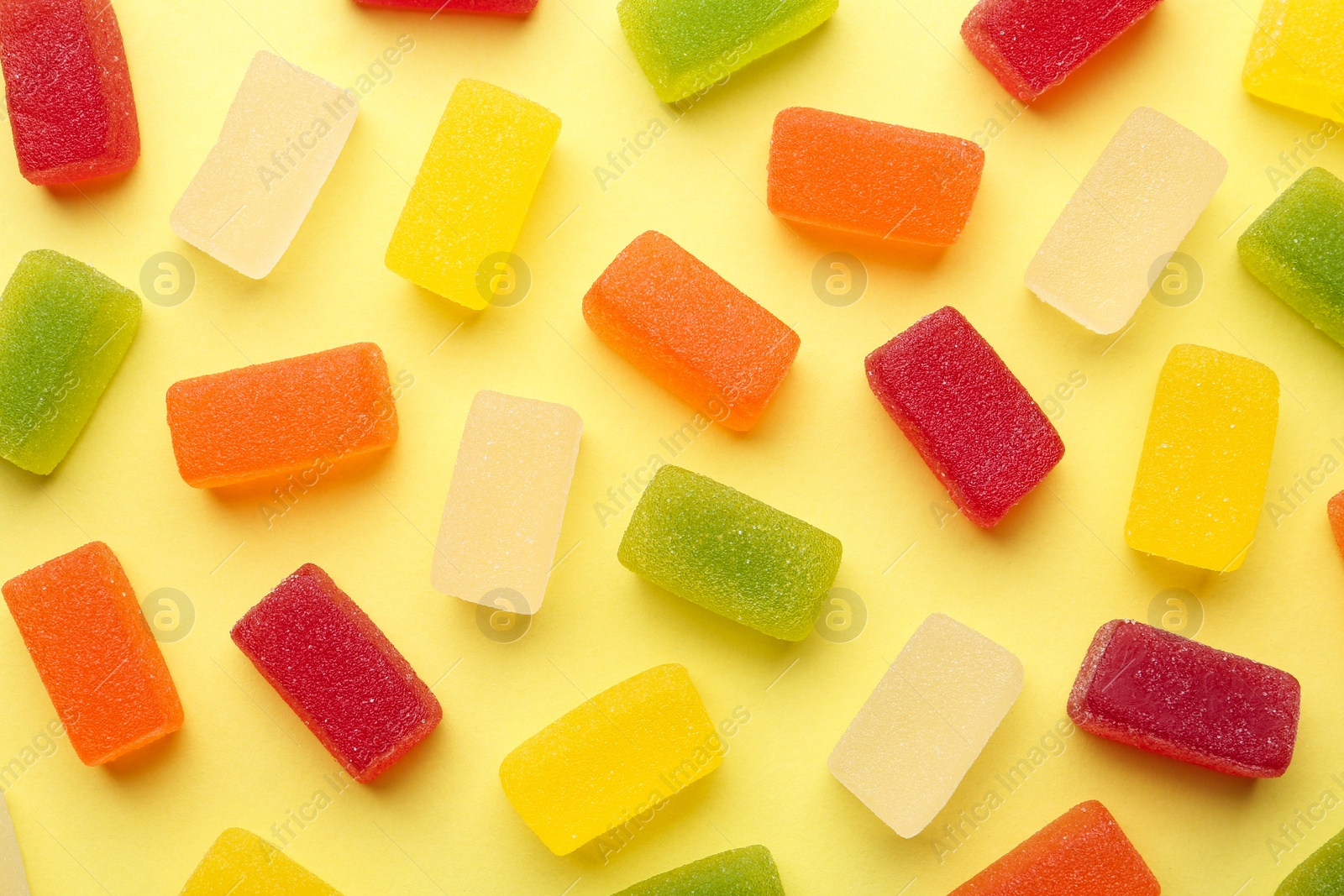 Photo of Tasty bright jelly candies on color background, flat lay