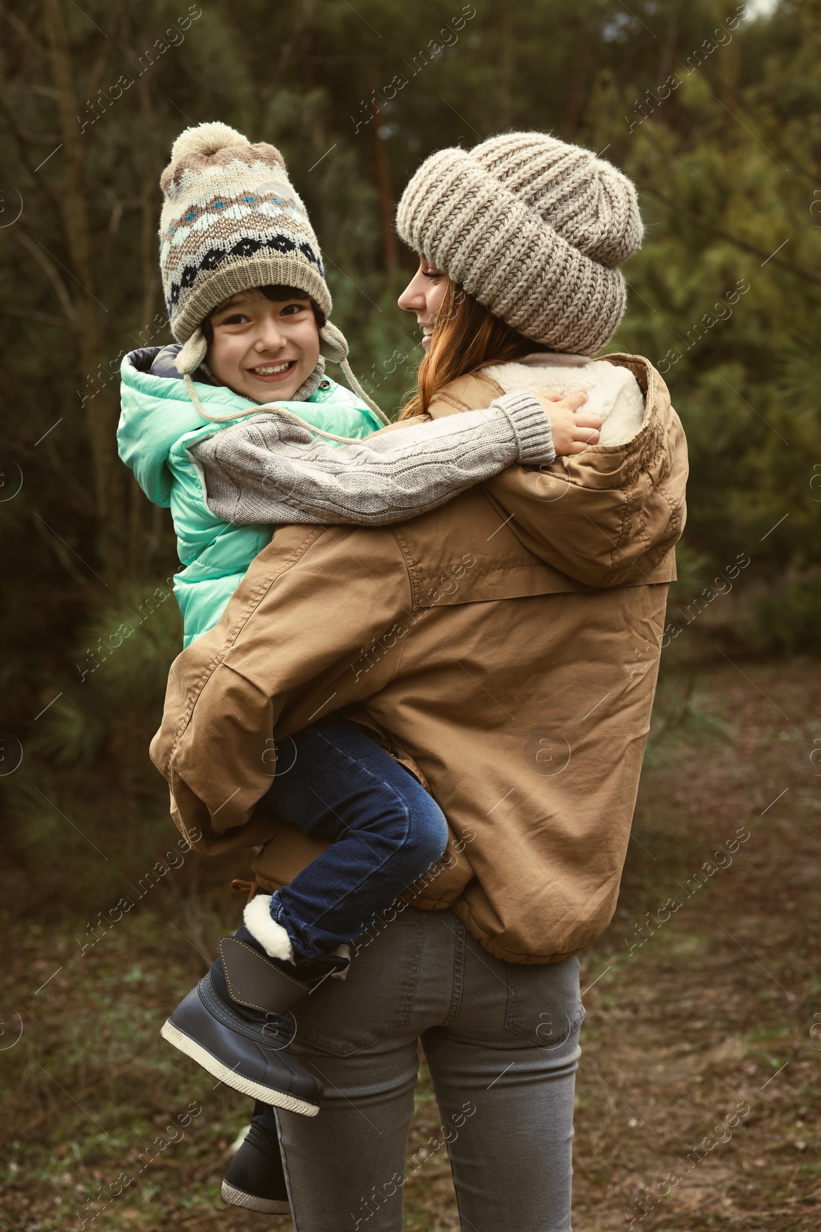 Photo of Woman and her son spending time together in forest