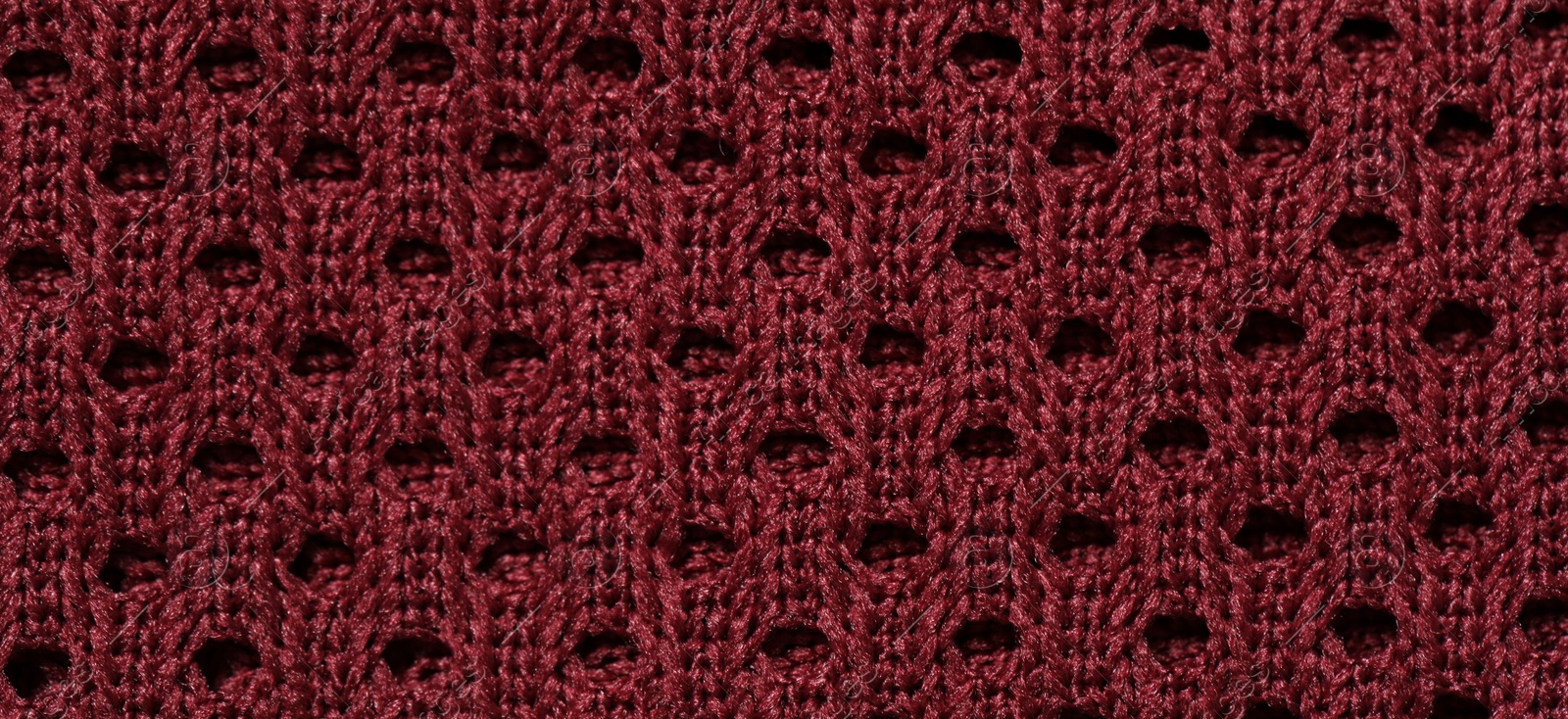Photo of Texture of burgundy knitted fabric as background, top view