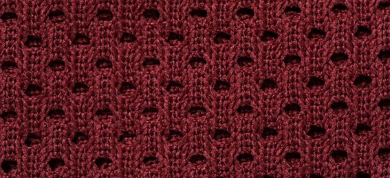 Photo of Texture of burgundy knitted fabric as background, top view