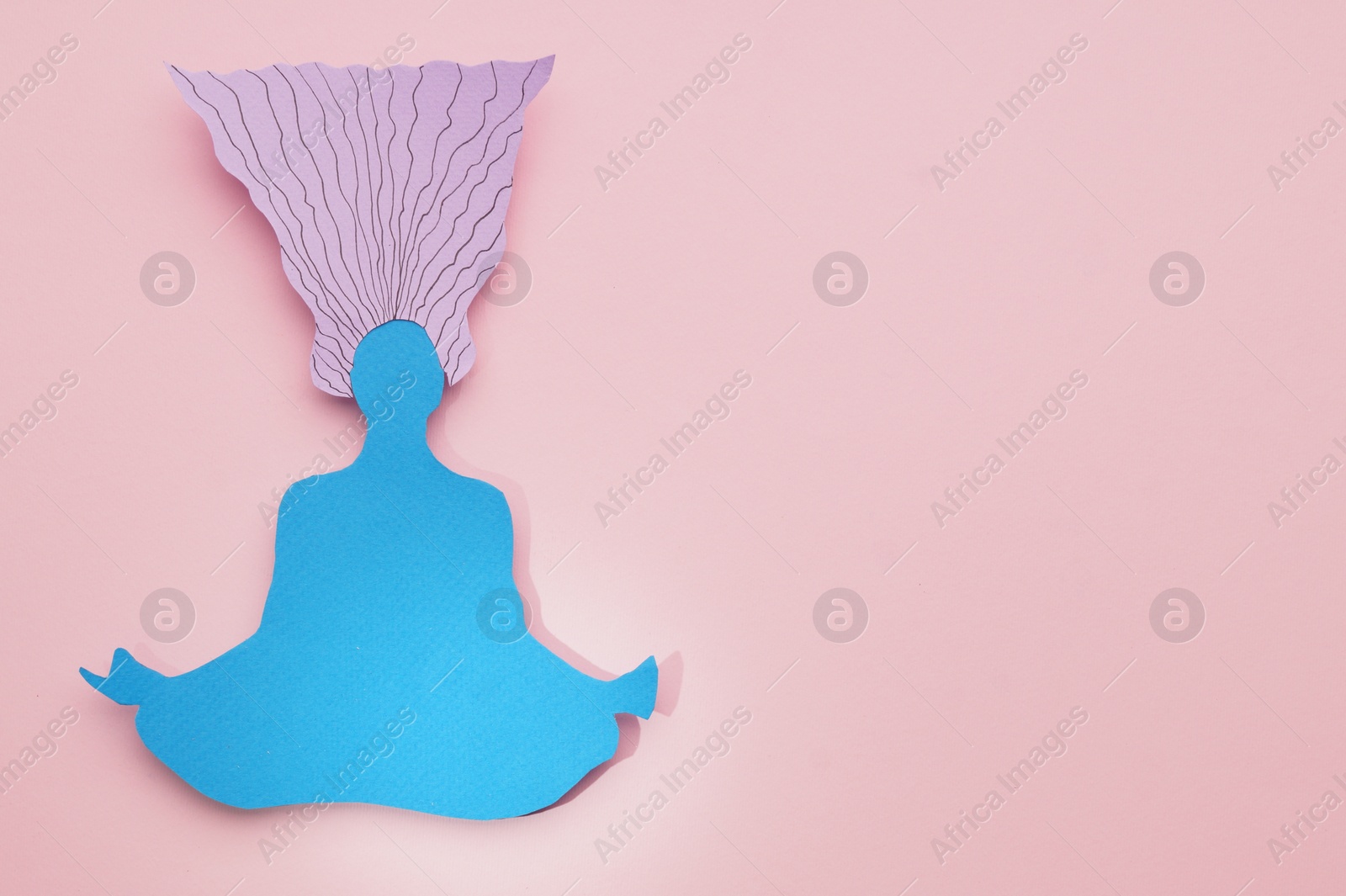 Photo of Woman paper figure on pink background, top view. Space for text