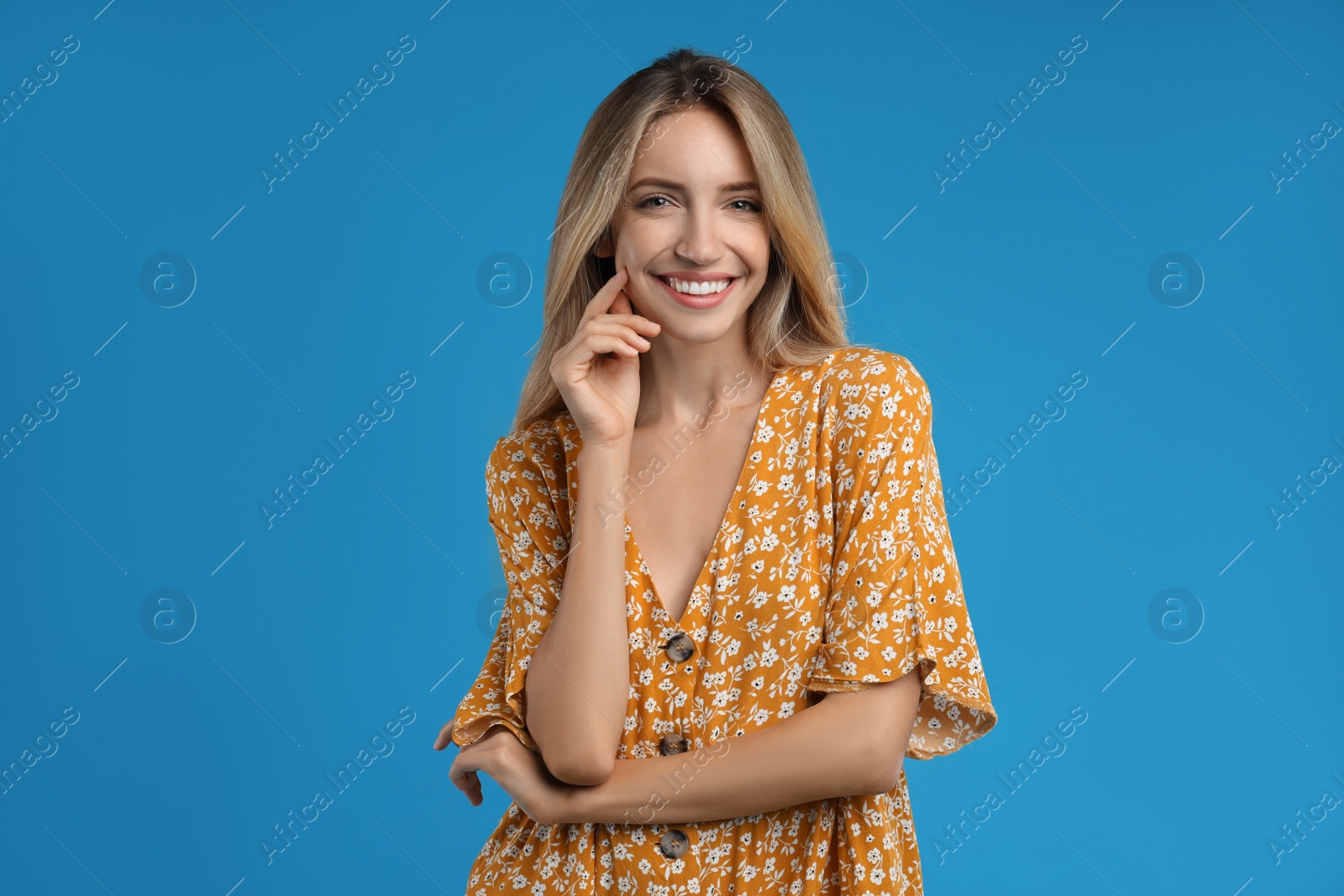 Photo of Young woman wearing stylish dress on blue background